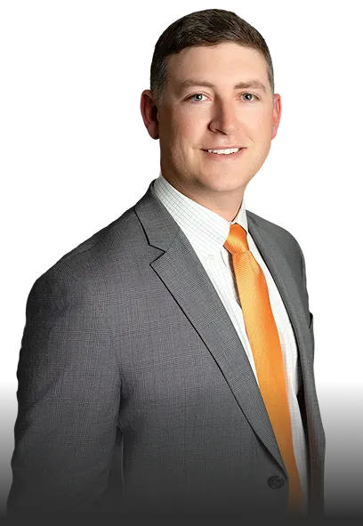Professional man wearing a gray suit, white shirt, and orange tie, smiling.