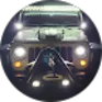 Front view of a dark green Jeep with headlights on at night.