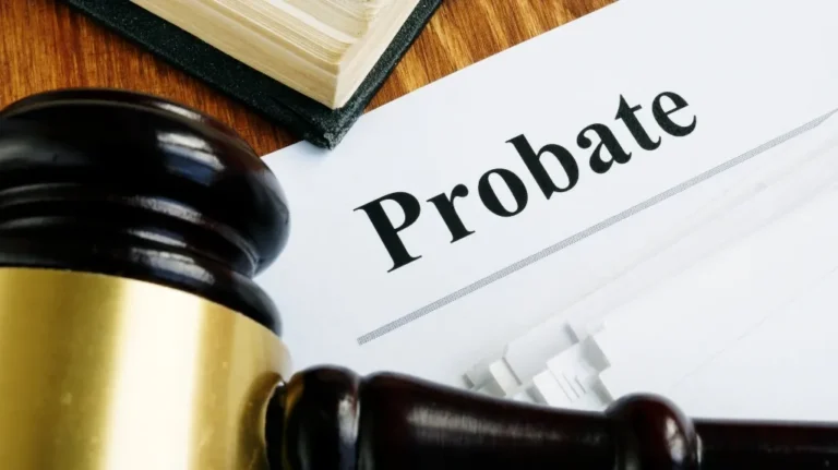 Close-up of a wooden gavel, legal book, and document titled "Probate" on a wooden surface.